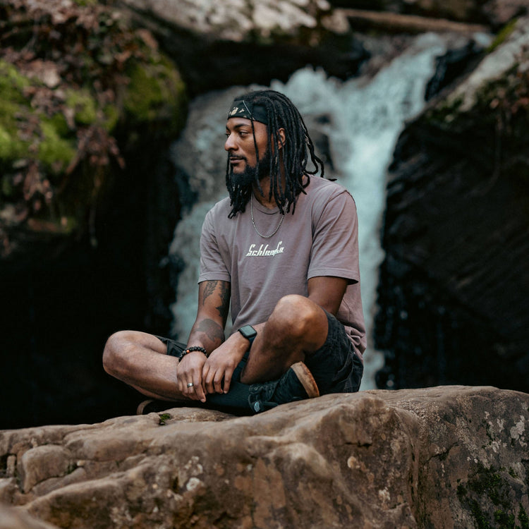 Schleepwear tee styled in front of a waterfall